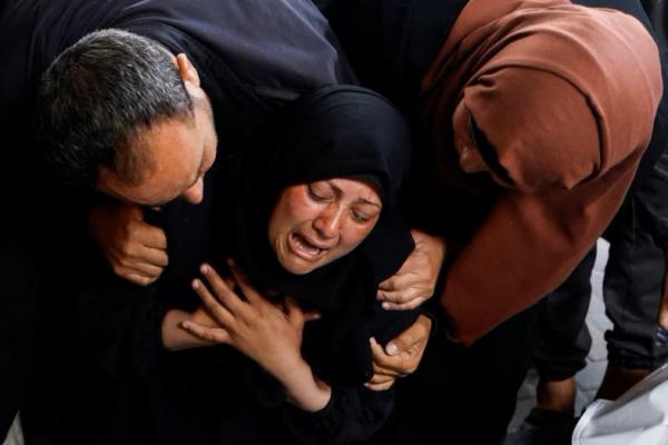 Seorang wanita bereaksi di samping jenazah warga Palestina yang tewas dalam serangan Israel, di selatan Jalur Gaza, 16 April 2024. REUTERS 