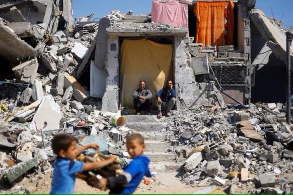 Warga Palestina duduk di rumah mereka yang hancur akibat serangan Israel, di Khan Younis, di selatan Jalur Gaza 14 Mei 2024. REUTERS 