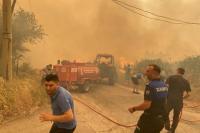 Petugas pemadam kebakaran dan penduduk setempat menanggapi kebakaran hutan di distrik Menderes, kota Izmir, Turki, 29 Juni 2025. IHA via REUTERS