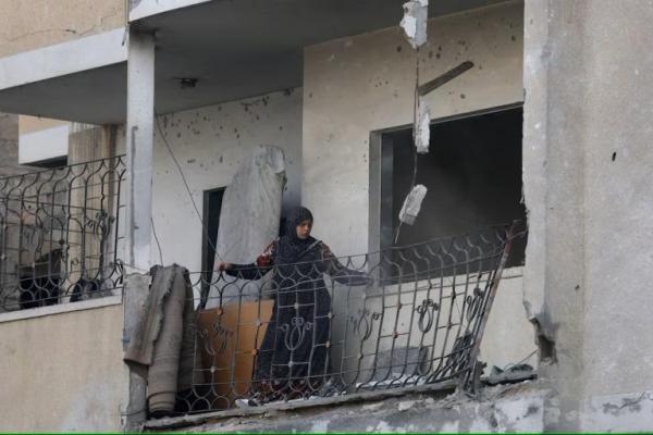 Seorang wanita Palestina melihat kerusakan, di lokasi serangan Israel terhadap sebuah rumah di Zawayda di Jalur Gaza tengah, 1 Juli 2025. REUTERS 