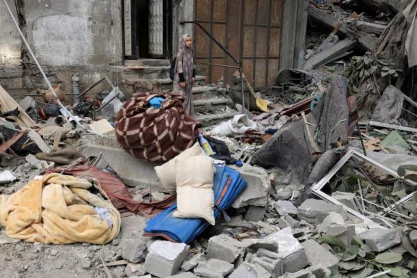 Seorang perempuan Palestina memeriksa lokasi serangan udara Israel semalam terhadap sebuah rumah di Kota Gaza, 7 Agustus 2025. REUTERS 