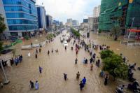 Orang-orang berjalan di jalan yang tergenang banjir setelah hujan monsun di Karachi, Pakistan, 19 Agustus 2025. REUTERS