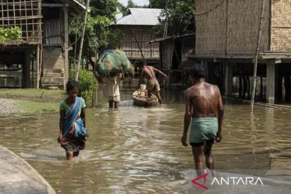 Ilustrasi warga menerjang banjir di sebuah desa di India. ANTARA/David Talukdar 