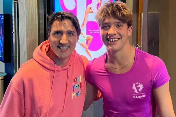 Canadian Prime Minister Justin Trudeau and his twin sons in pink dresses watch Barbie movies